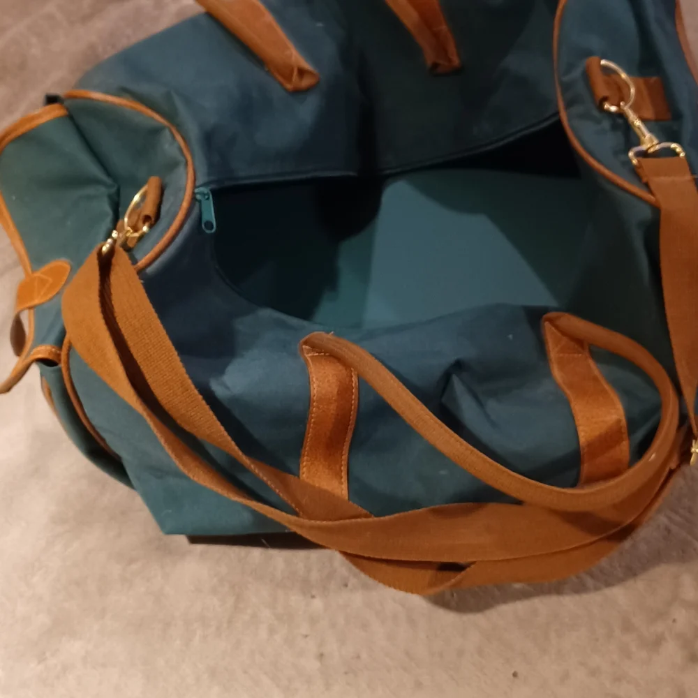 Duffle bag fancy straps are nice accents to this bag